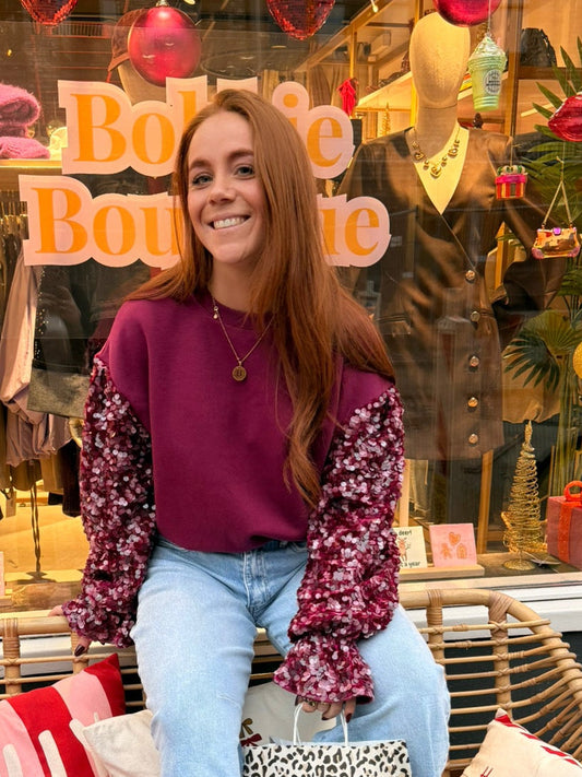 Paarse sweater met pailletten mouwen