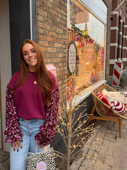 Paarse sweater met pailletten mouwen